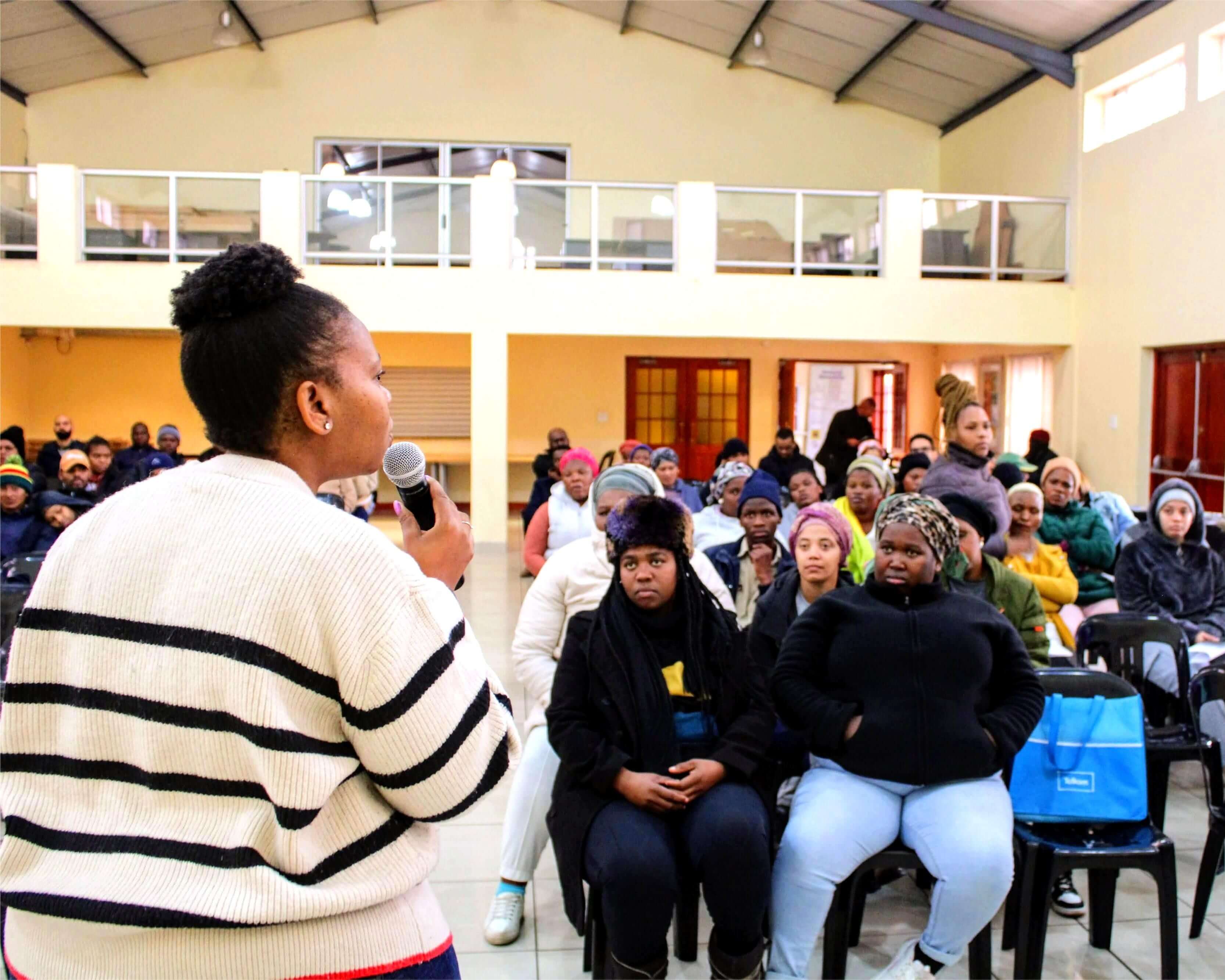 A woman speaking with a group of people